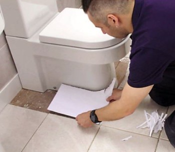 Do you have to remove toilet to tile bathroom floor