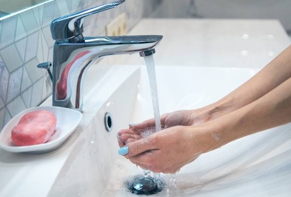 How does water drain from a sink?