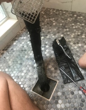 Why is there black stuff coming out of my shower drain?