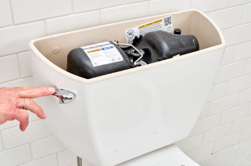 How does a pressure assist toilet work?