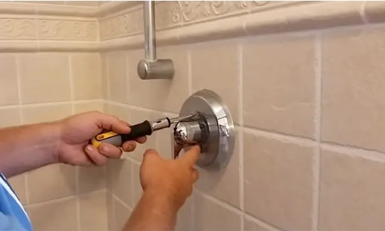 How do you use a shower handle puller?